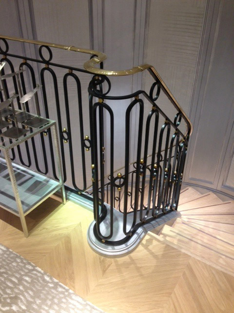 Looking down the shop staircase with cast iron and brass stair balustrade.