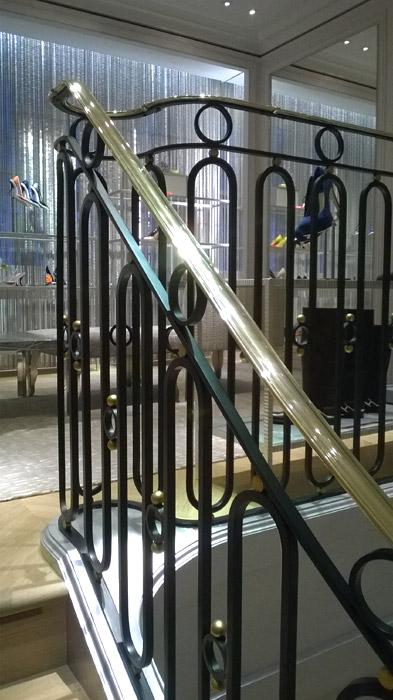 Decorative steel, iron and brass stair balustrade in London retail premises.