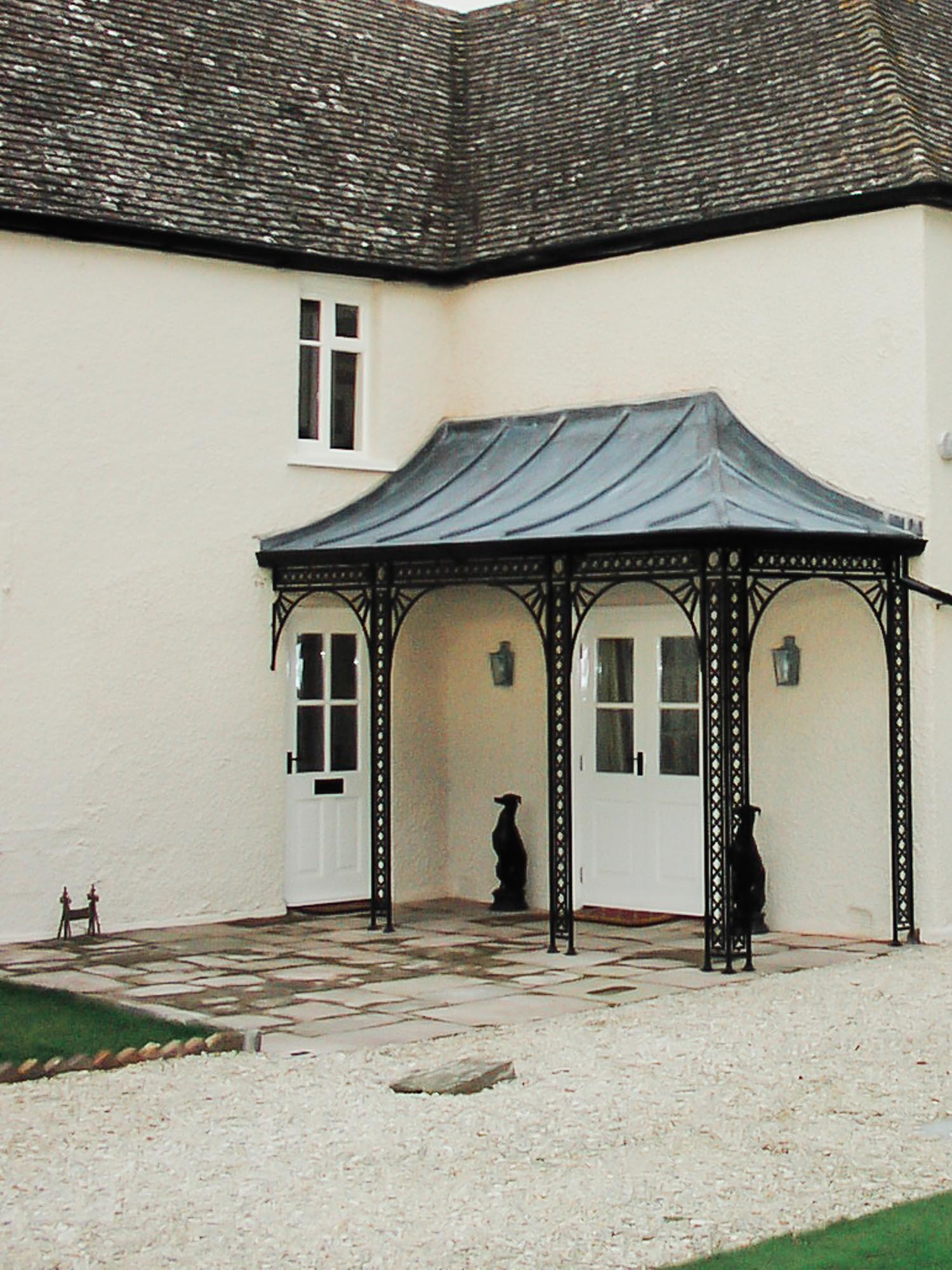 Wrought Iron Traditional Georgian Design Corner Porch Awning to cover a Front Door and French Doors with a Lead covered Roof Frame Canopy