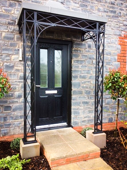 Regency Traditional Ironwork metal Porch Portico Awning with Natural Stone Plinths and Cast Iron shoes finished with Complete Zinc Roof Canopy Cover Powder-coated in a Lead grey colour and sunray spandrel Brackets