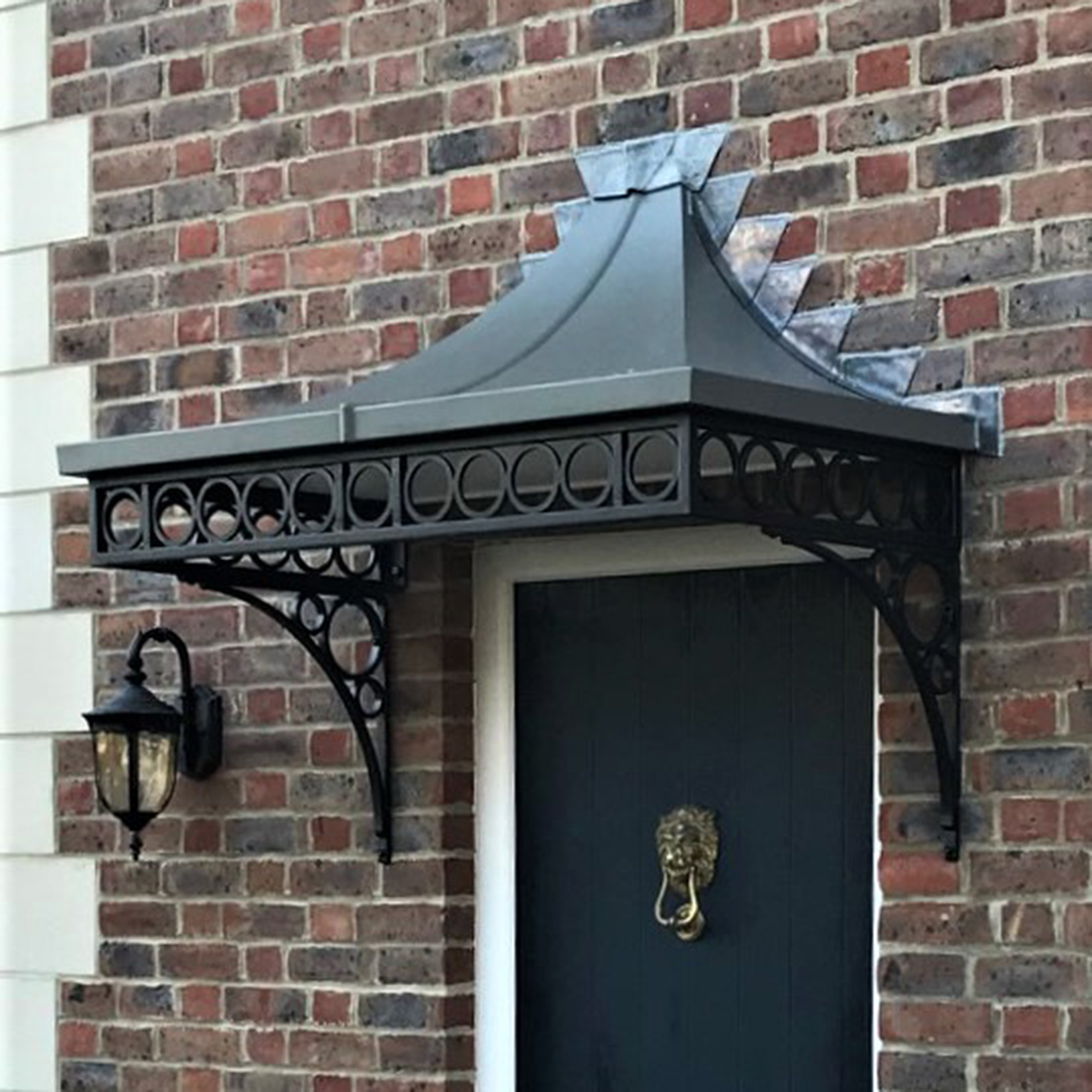 A complete roof on a cantilever door canopy with lead flashing