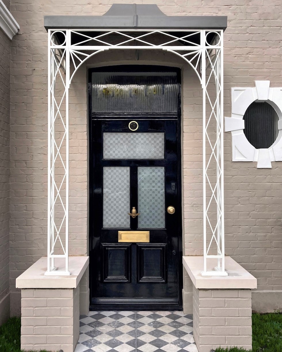 Regency design wrought iron door porch on brick plinths with our popular zintec roof awning which has been powder-coated in a lead grey